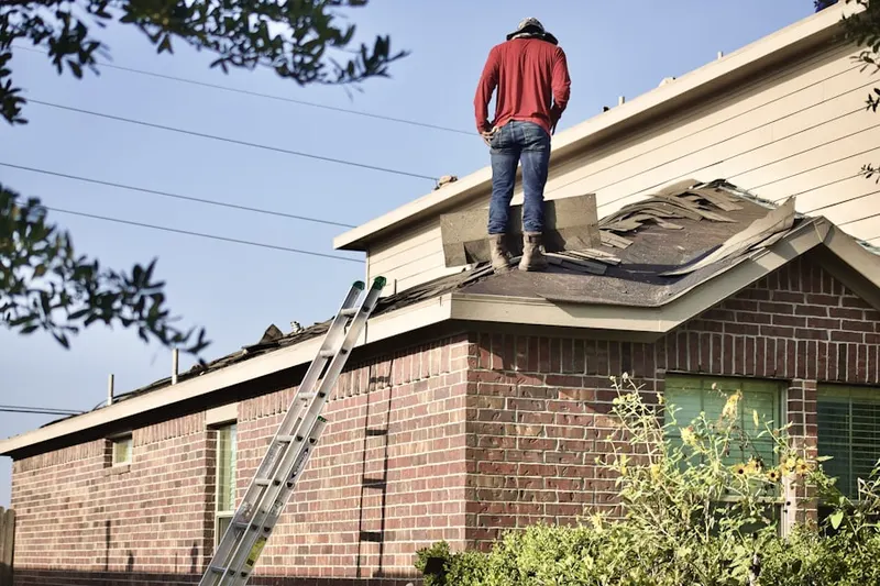 Professional roofer working on a residential roof in Woodway